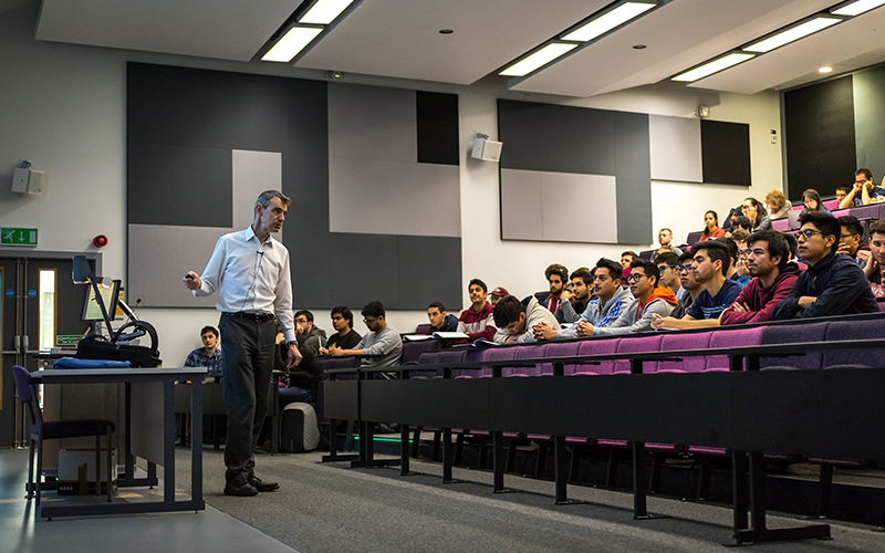 Students sat in lecture theatre, watching an engineering lecture